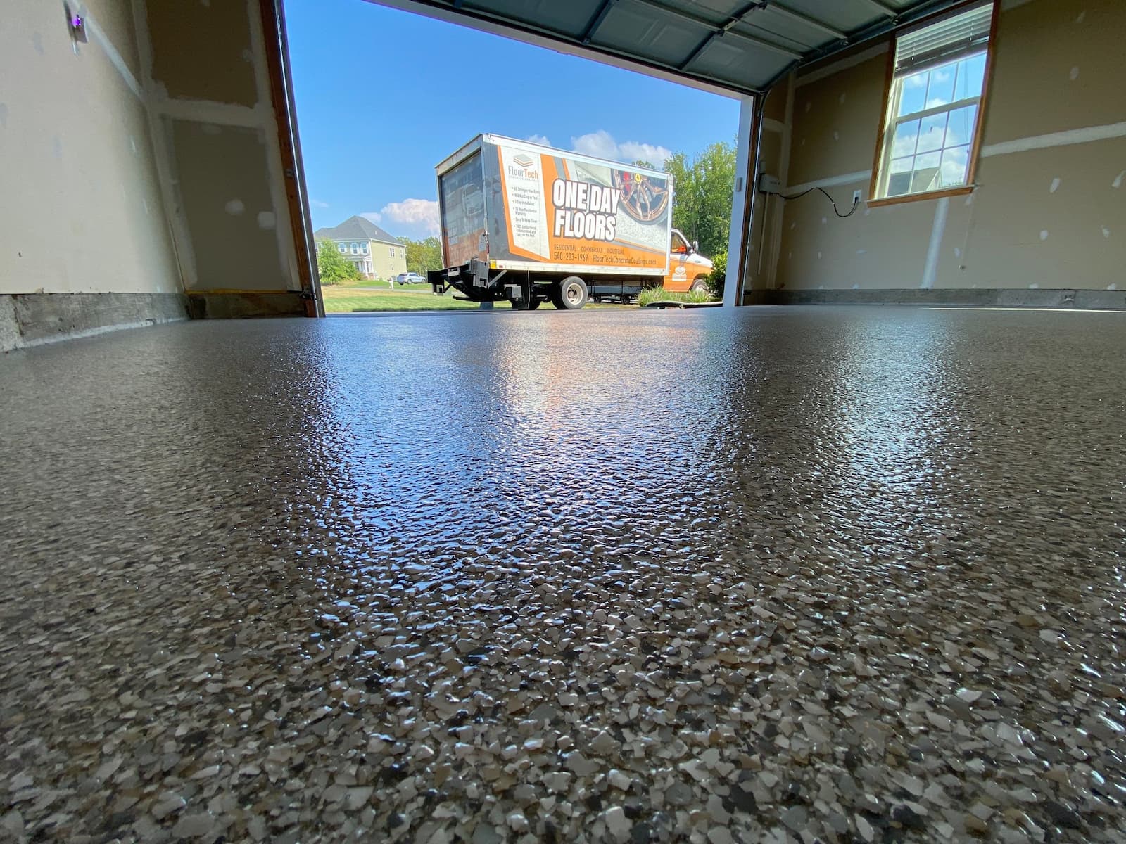 floortech truck sits outside of freshly coated garage concrete floor