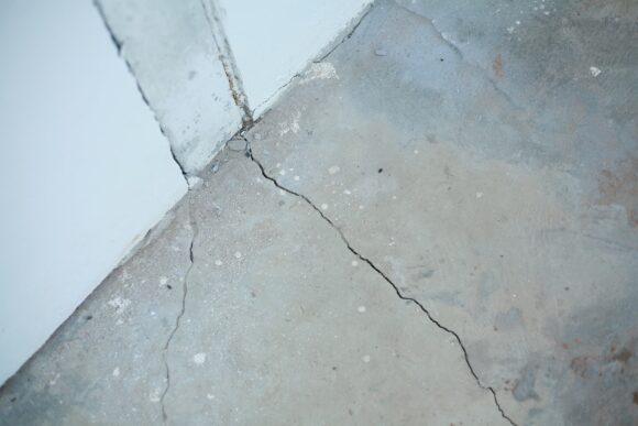 cracked concrete in need of repair before coating