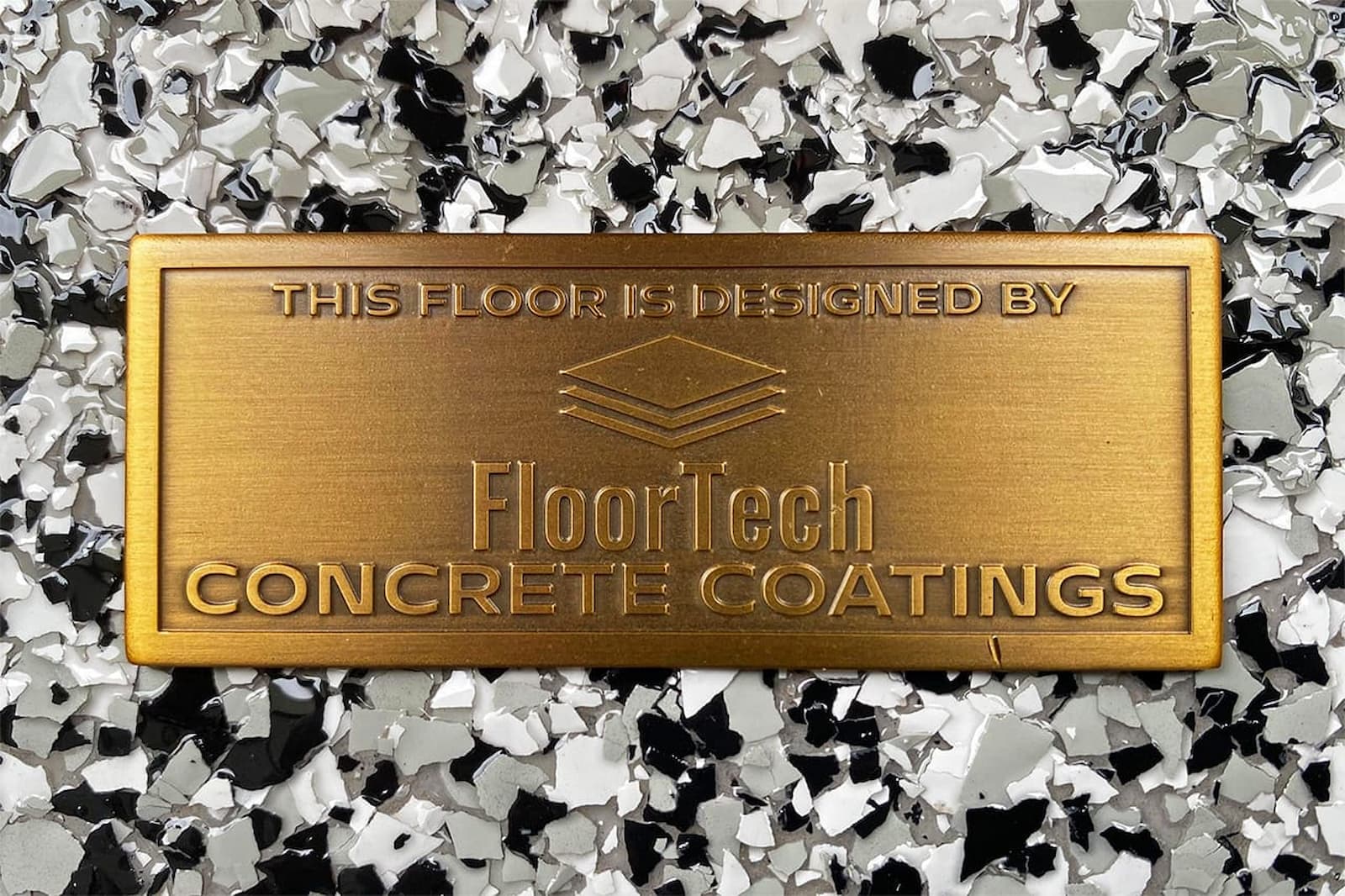 floortech logo emblem atop concrete coating surface