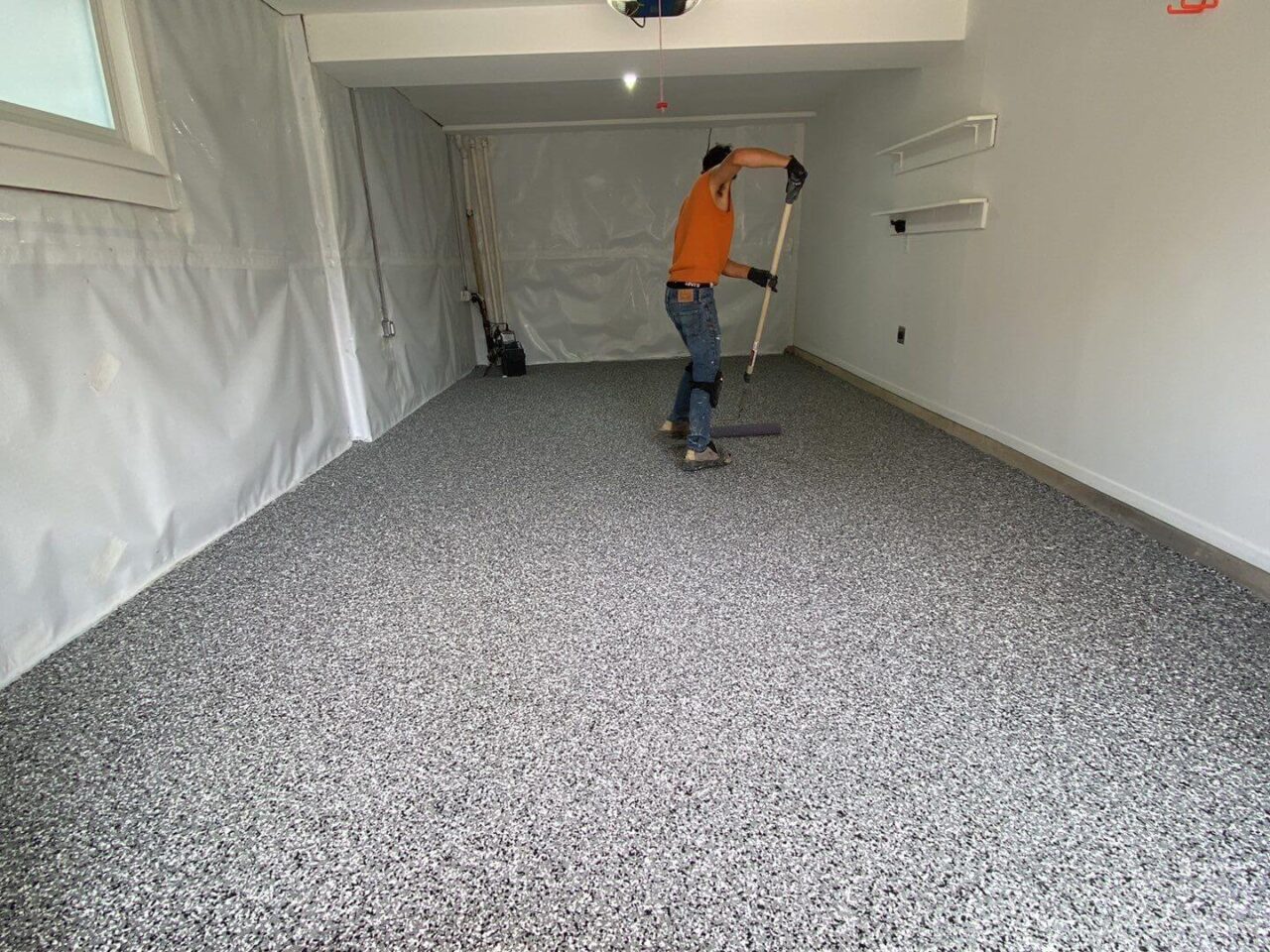 floortech installer applying polyaspartic top coat