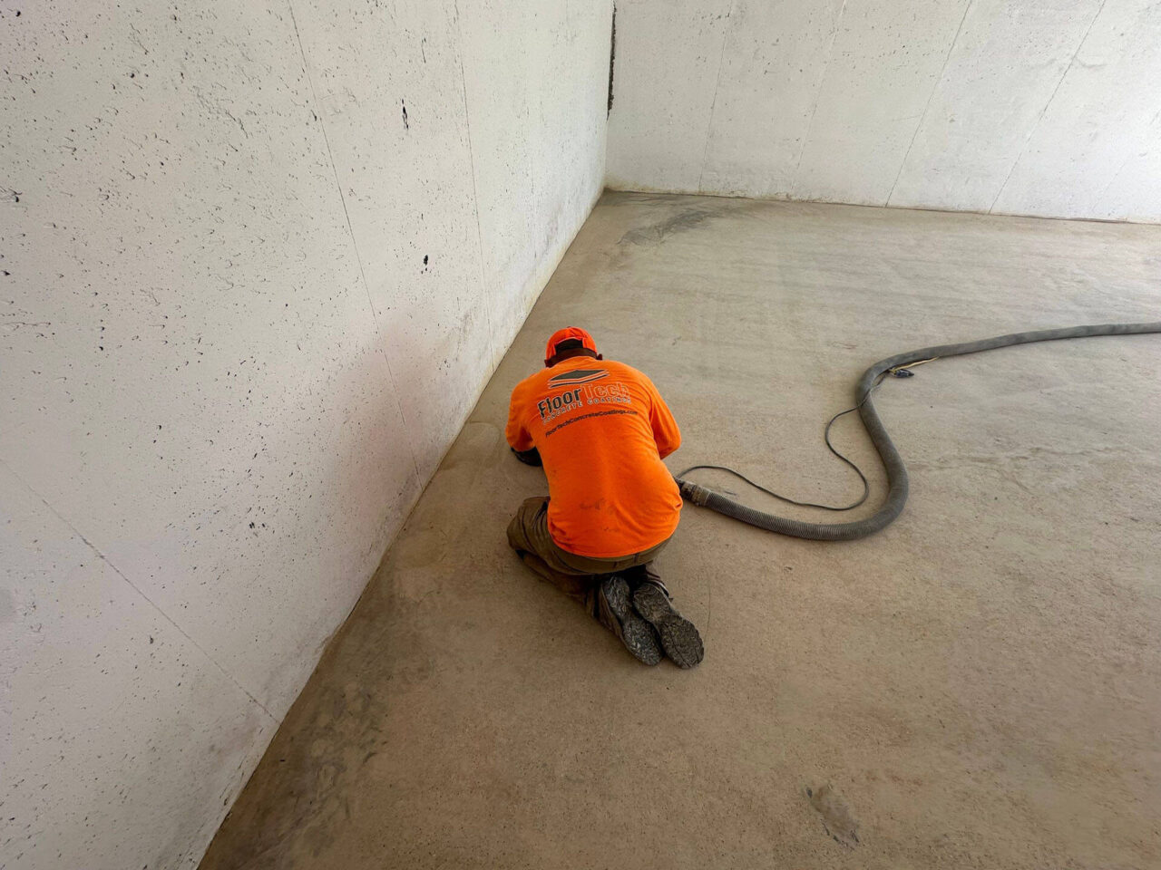 floortech installer grinding garage floor with hand grinder