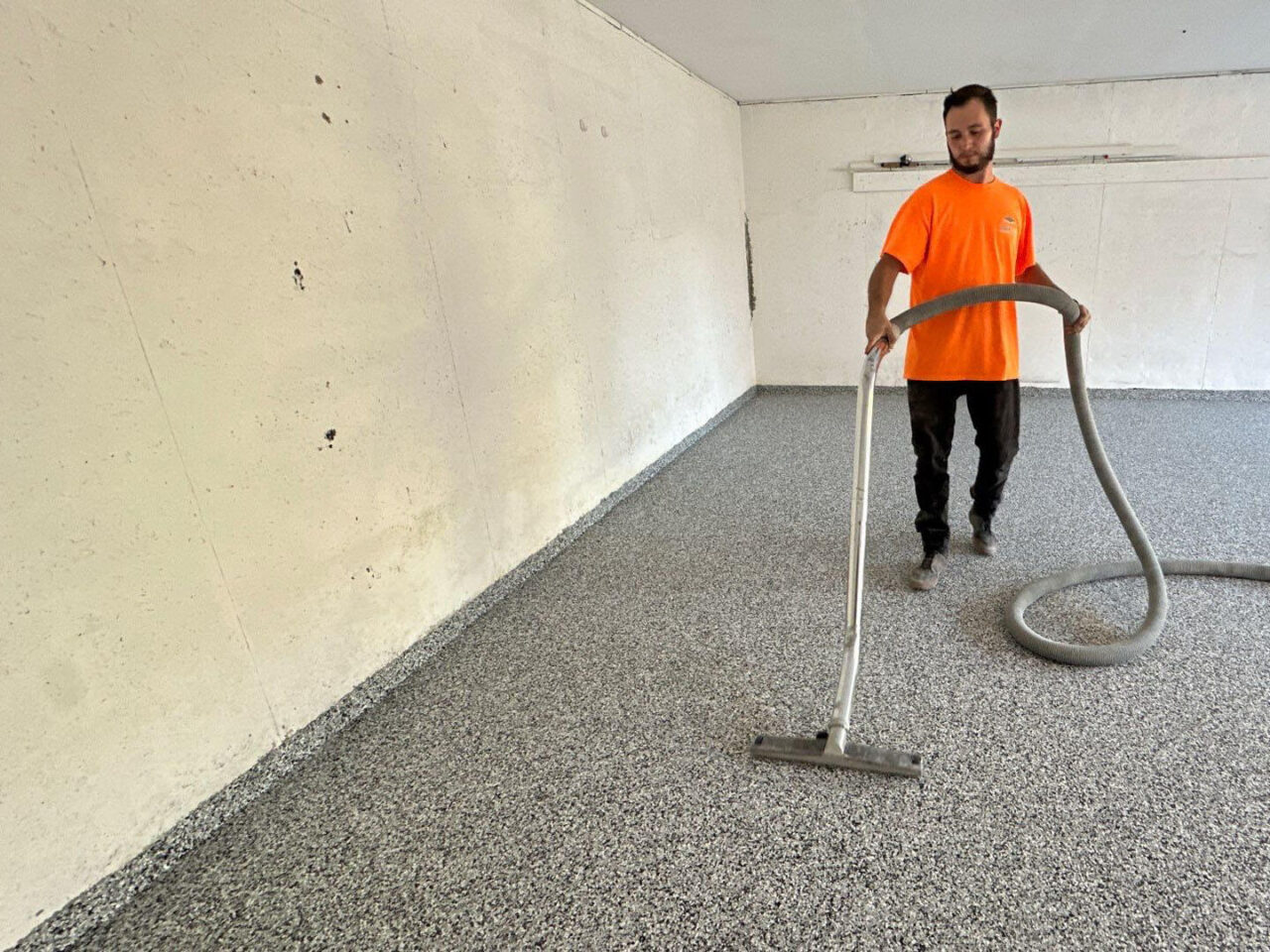 floortech installer vacuuming excess flake