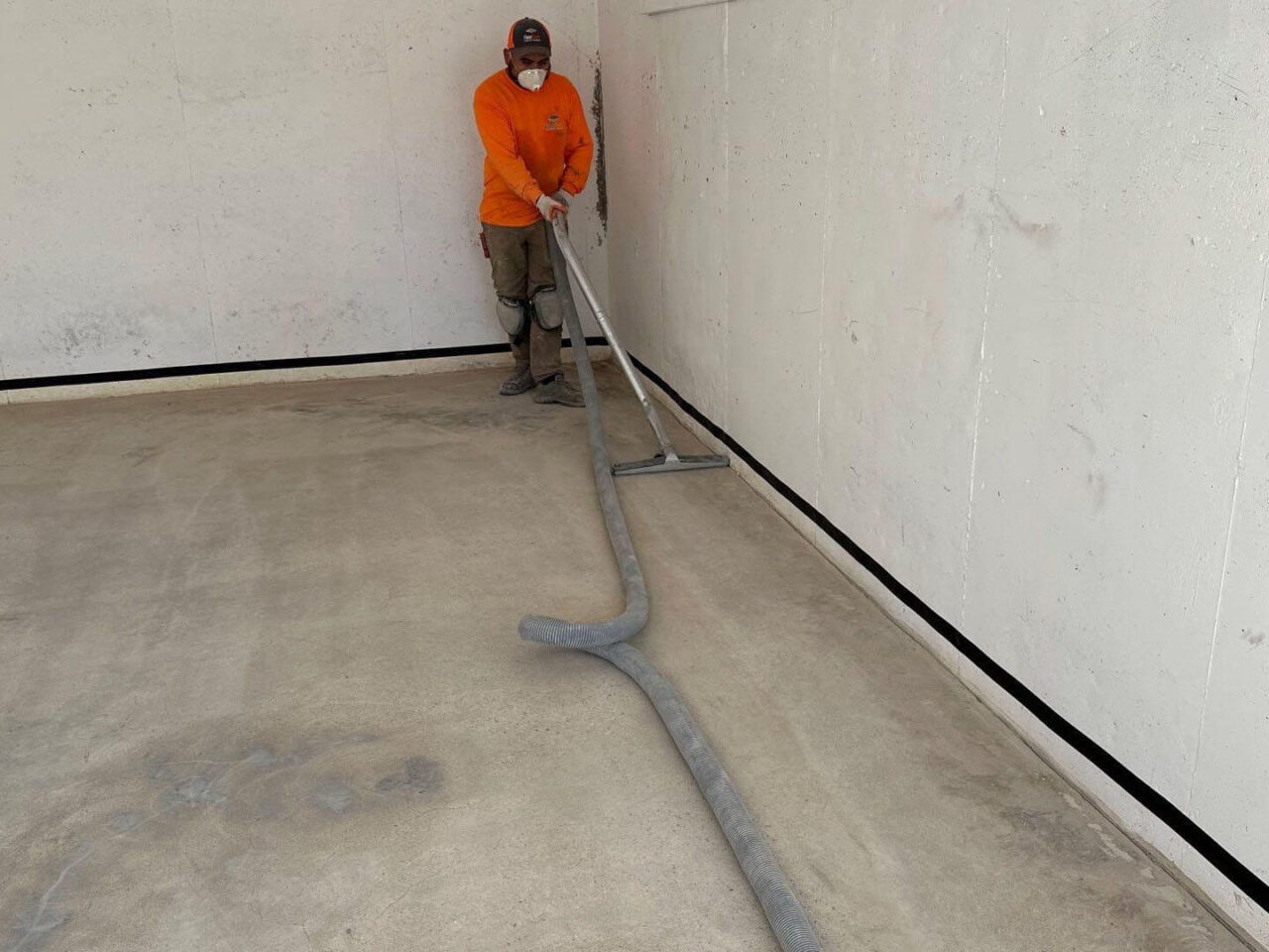 floortech installer vacuuming dust after grinding