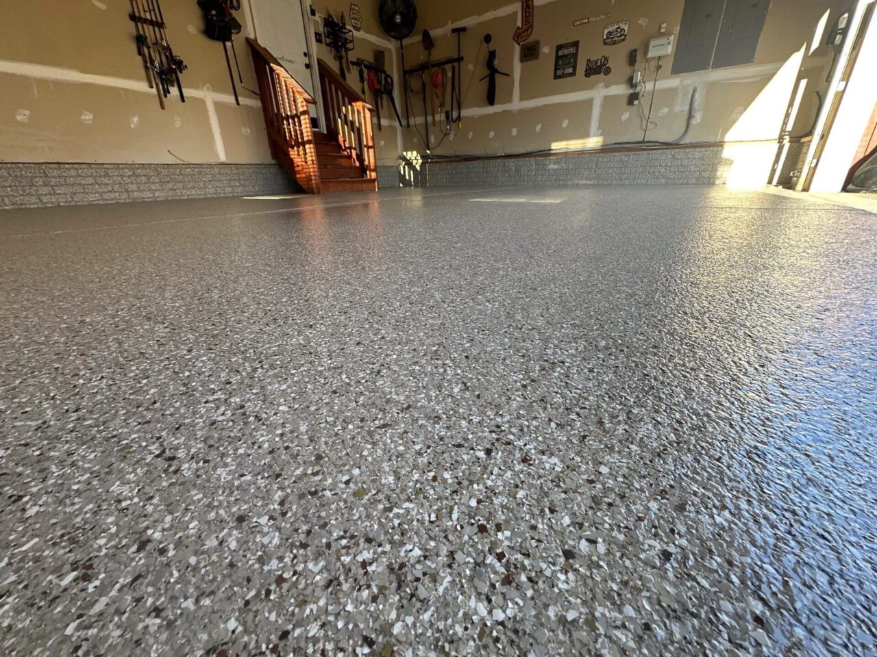Glossy final surface reflecting sunlight in newly coated garage.