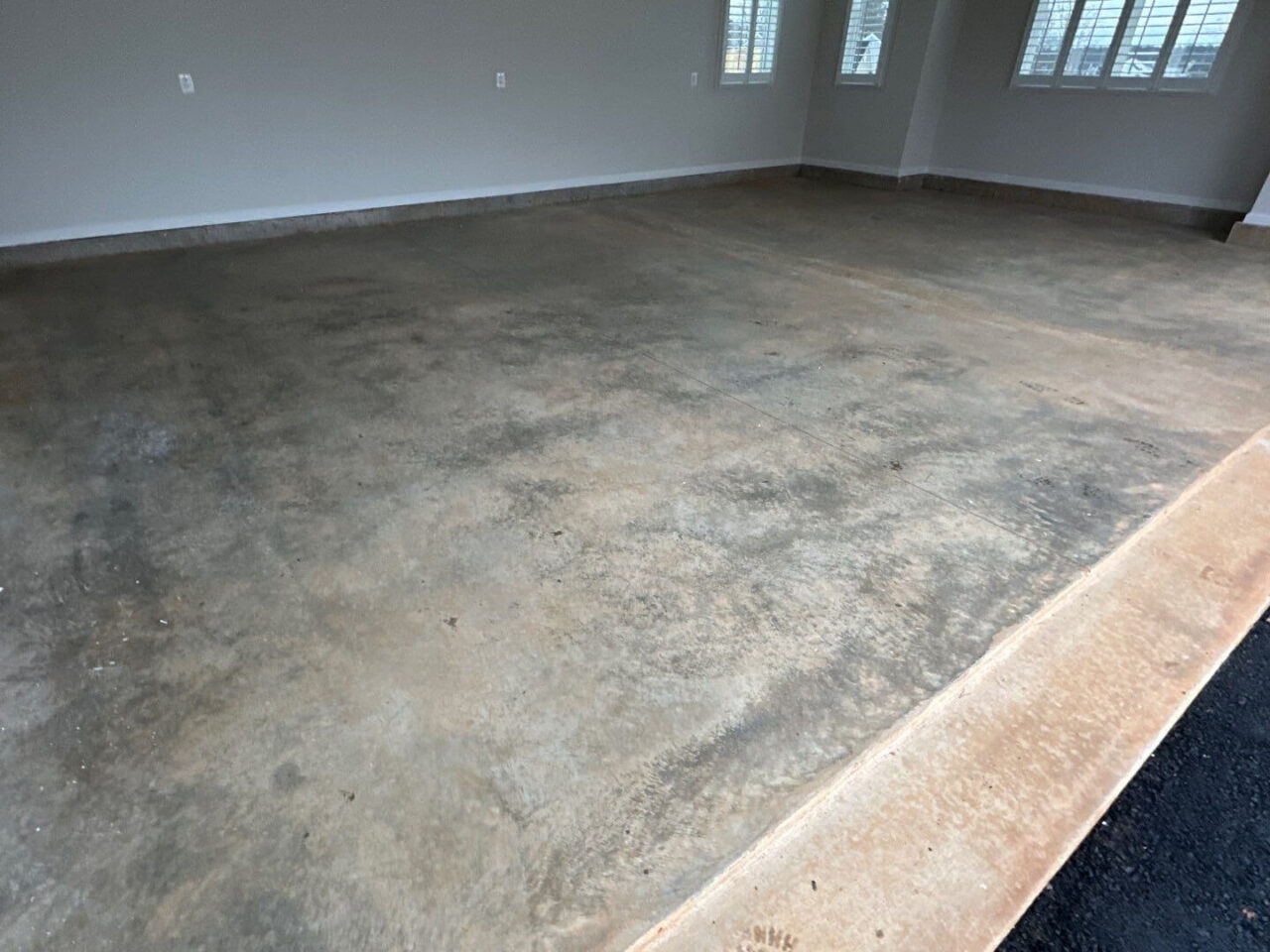 Unfinished wooden stairs and bare concrete before flake system application.