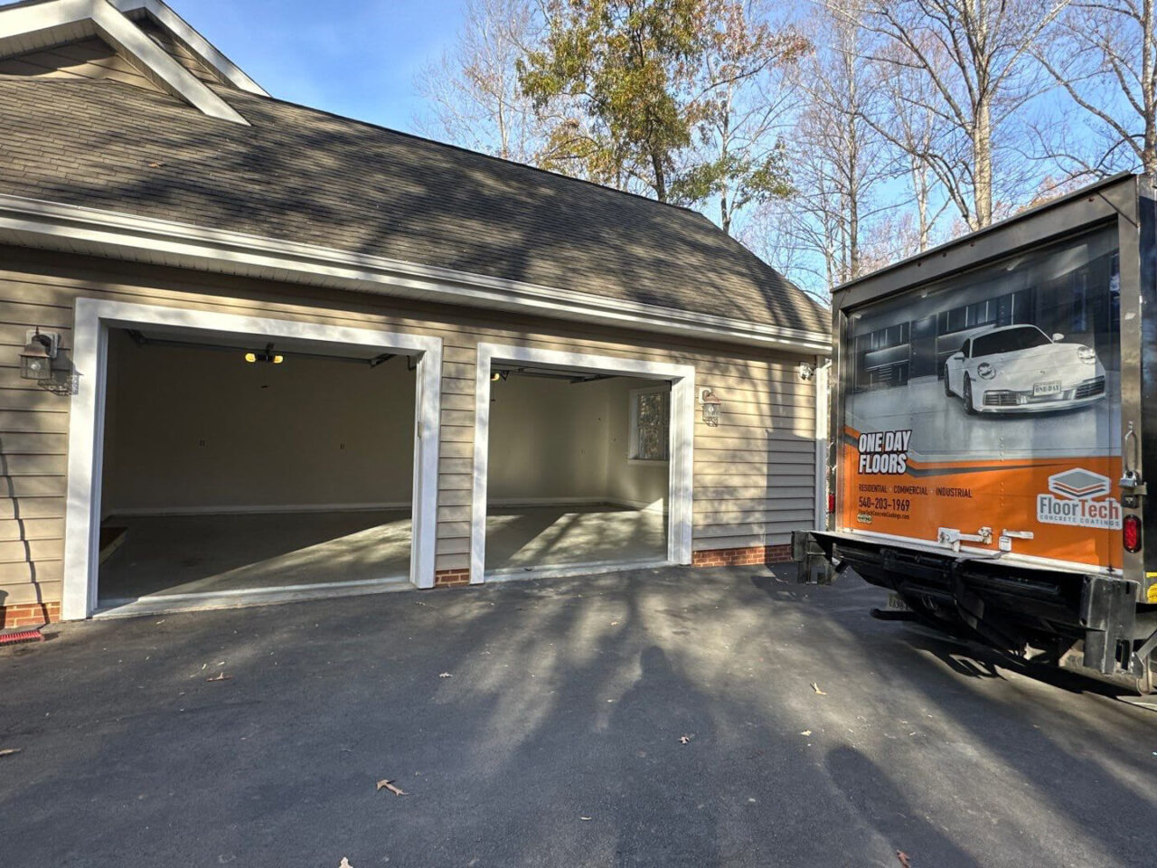 Exterior of Culpeper home with FloorTech truck parked beside open three-car garage.