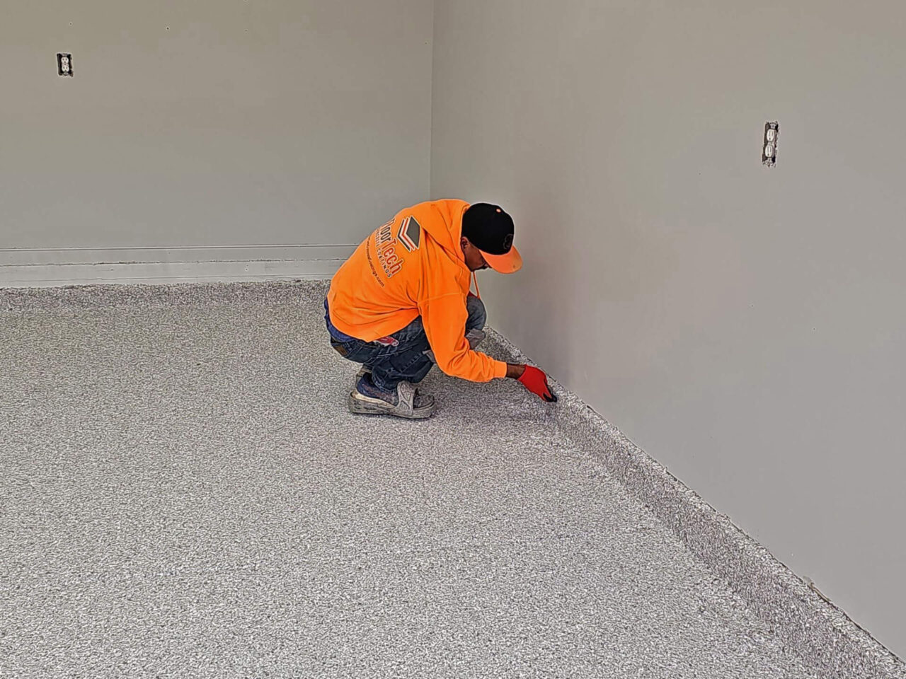 Domino flake shown mid-application on tacky base coat during installation.