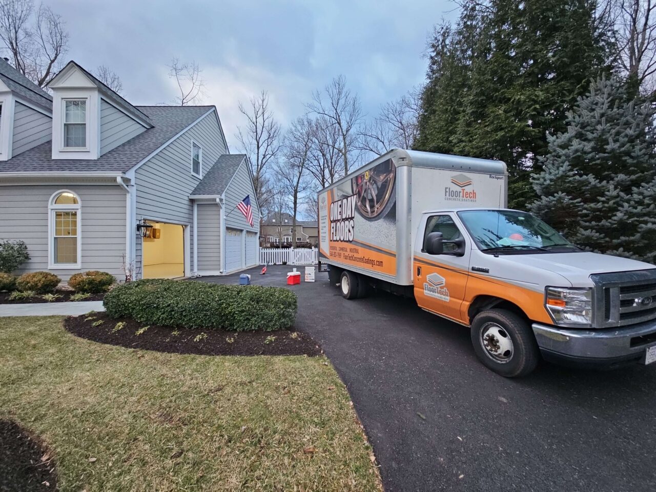 FloorTech truck parked outside finished garage in Reston