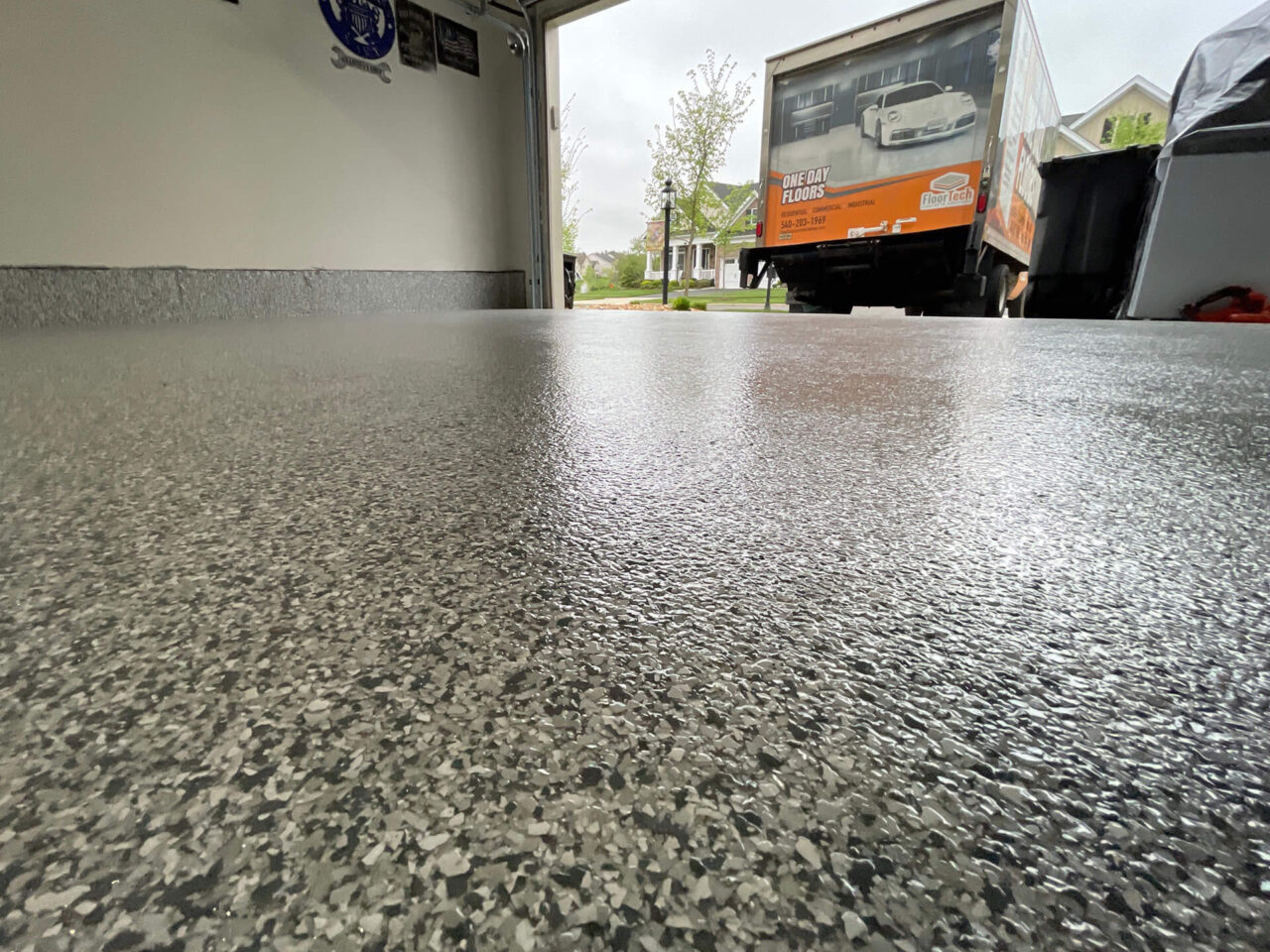 FloorTech truck outside a Gainesville home with the new garage floor just inside the open bay.