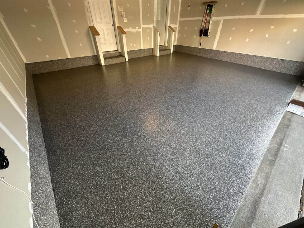 Angled shot of the completed garage showing two coated entry steps