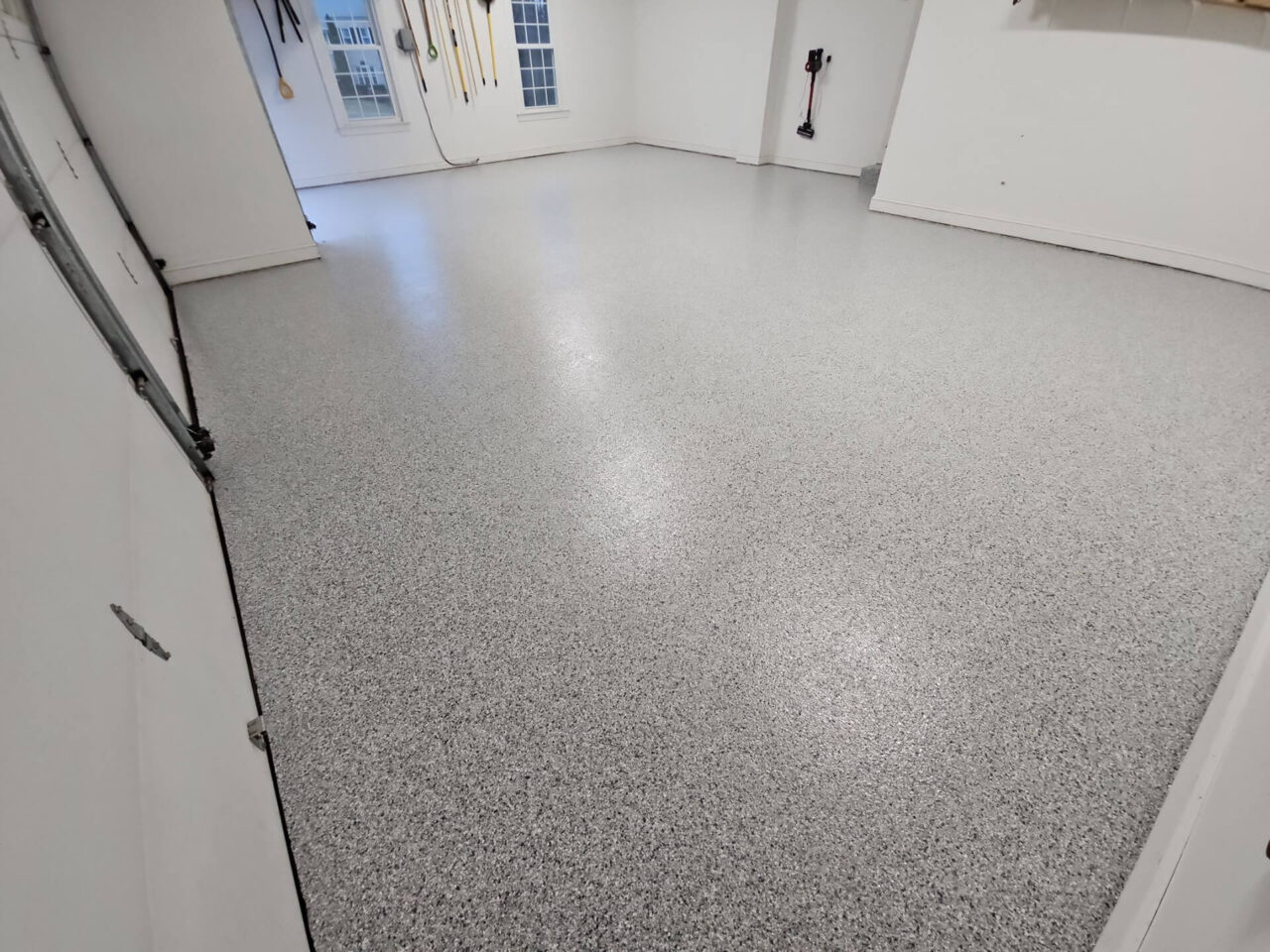 Coated garage floor with Tidal Wave flake and white trim