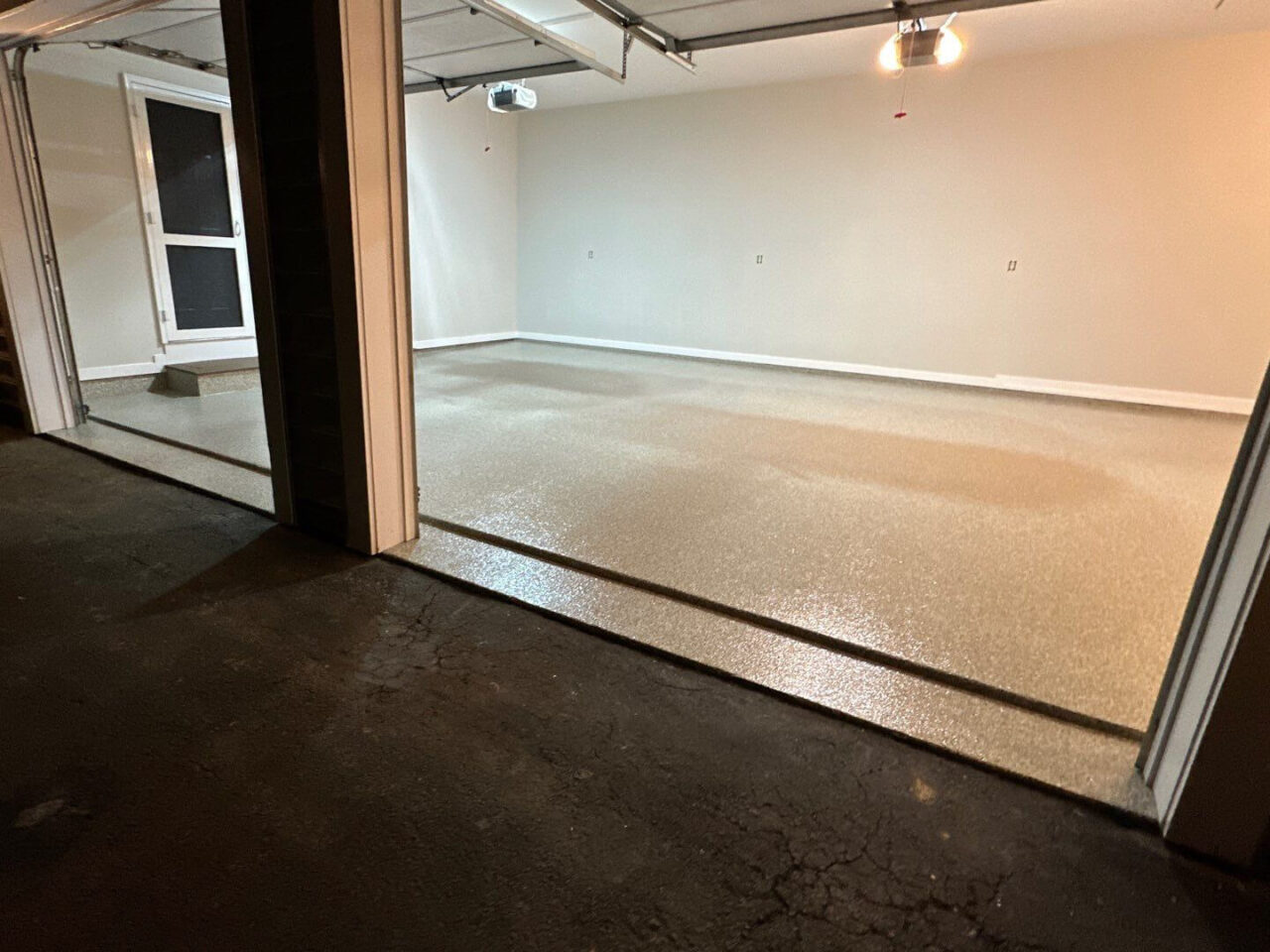 Garage floor coating complete with smooth finish and reflection from overhead lighting.
