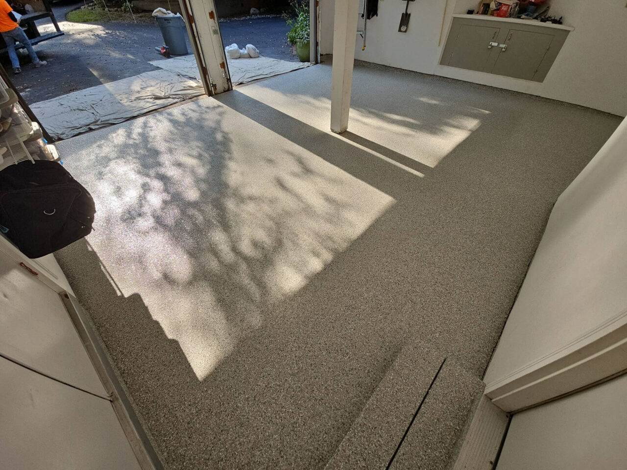 Angle showing coated stem walls and center post in a well-lit garage after coating.