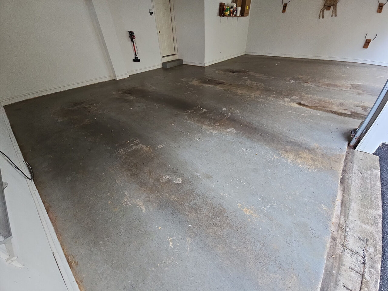 Worn painted garage floor before resurfacing