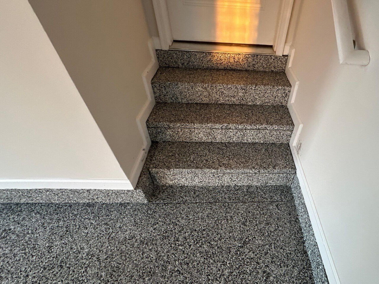 Stairs leading into the house, fully coated in Domino flake for a clean transition.