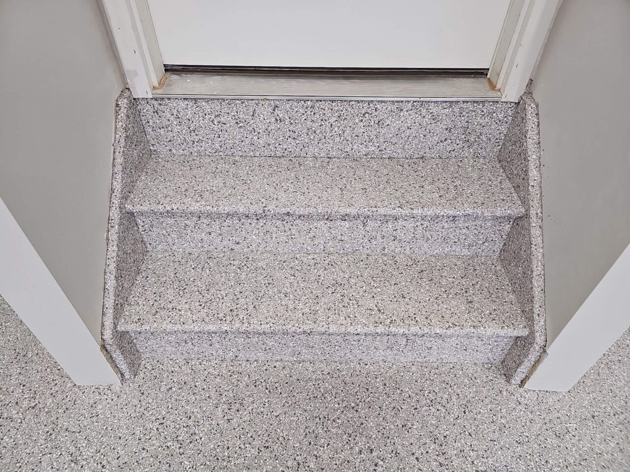 Stairs leading into the home fully coated in Mount Everest flake for a seamless finish.