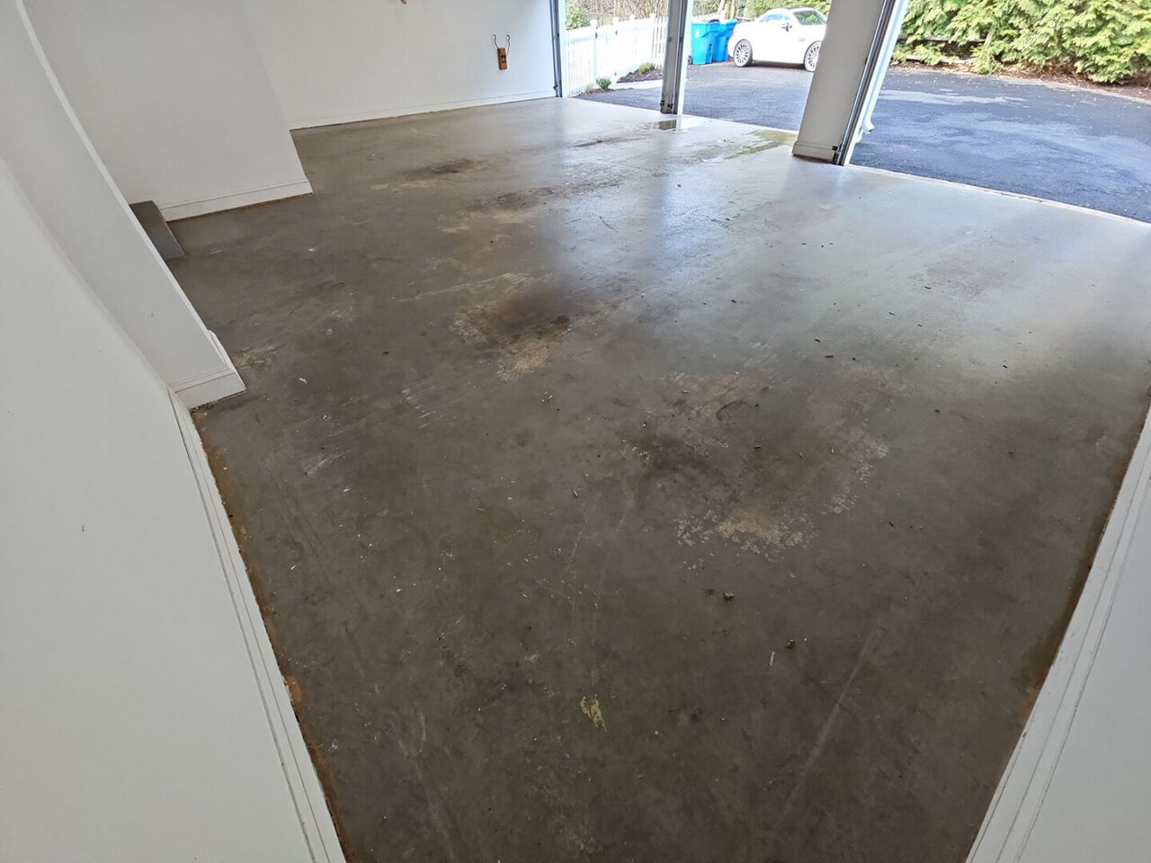 Wide angle of entire garage before floor upgrade
