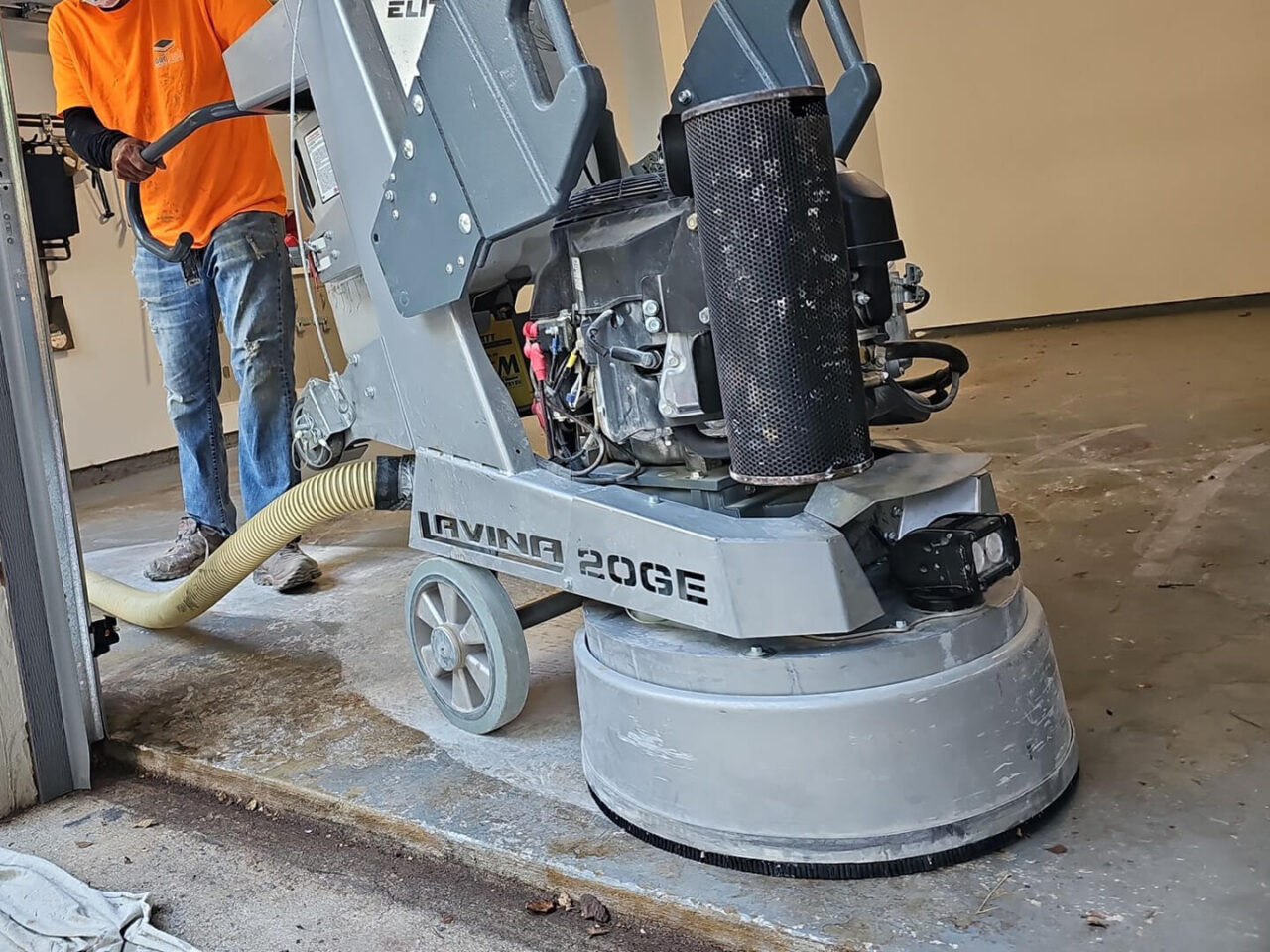 Floor grinding in progress with industrial Lavina machine removing old coating for prep.