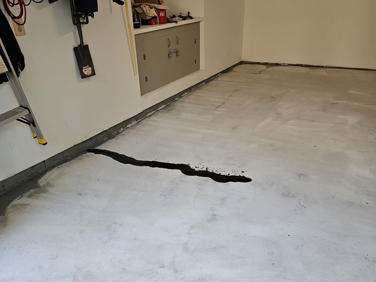 Large crack filled with repair compound during concrete surface prep stage.