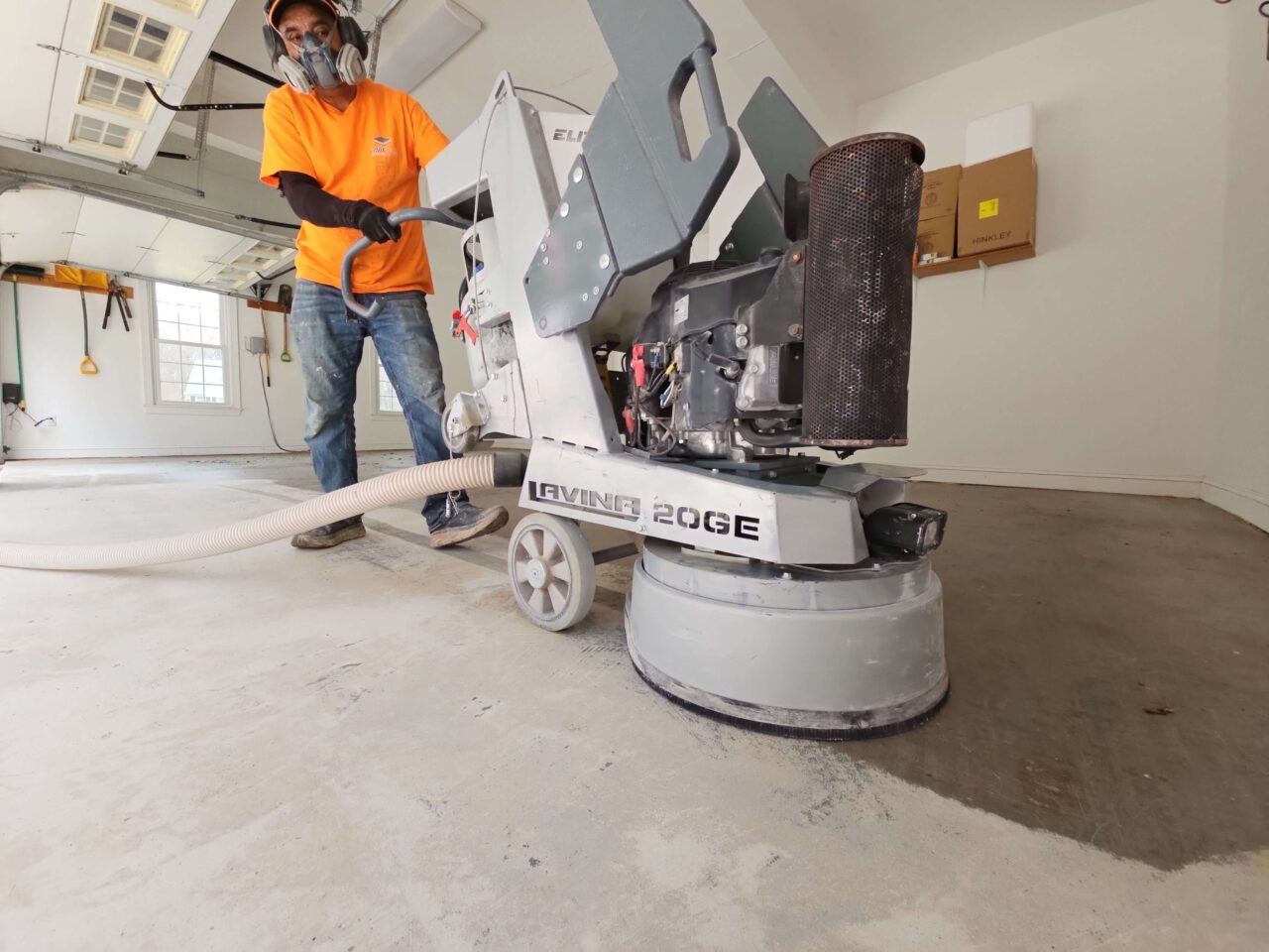 FloorTech installer grinding garage floor with Lavina machine