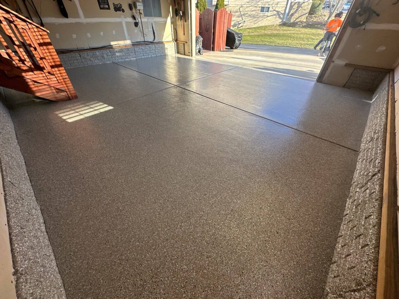 Completed polyurea flake floor with clean, even finish and coated stem walls.